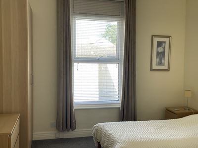 second bedroom showing twin beds and wardrobe